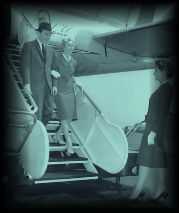 Passengers coming down the airstairs, met at the bottom.